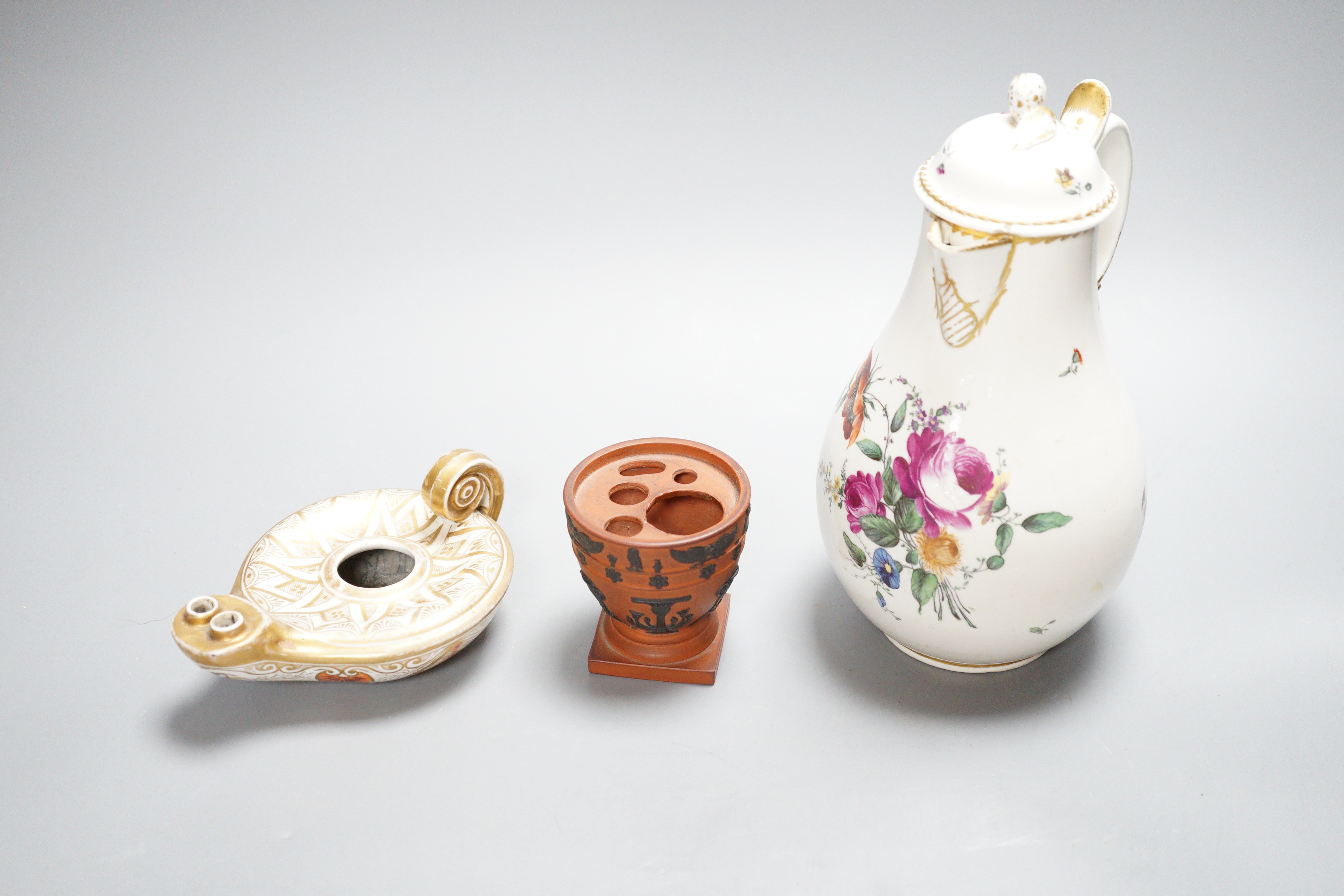 An 18th century English porcelain hot water jug, a Wedgwood two-colour terracotta pot and an early 19th century oil lamp, tallest 20cm